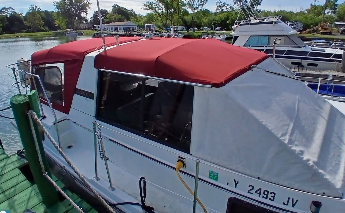 Red and gray custom camper canvas installed on a cabin boat