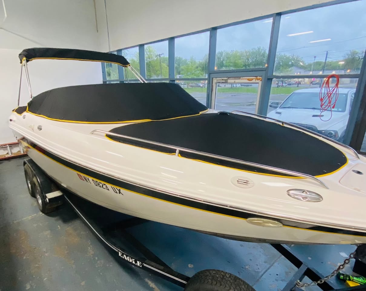 Custom black snap-on cockpit and bow cover on white performance boat