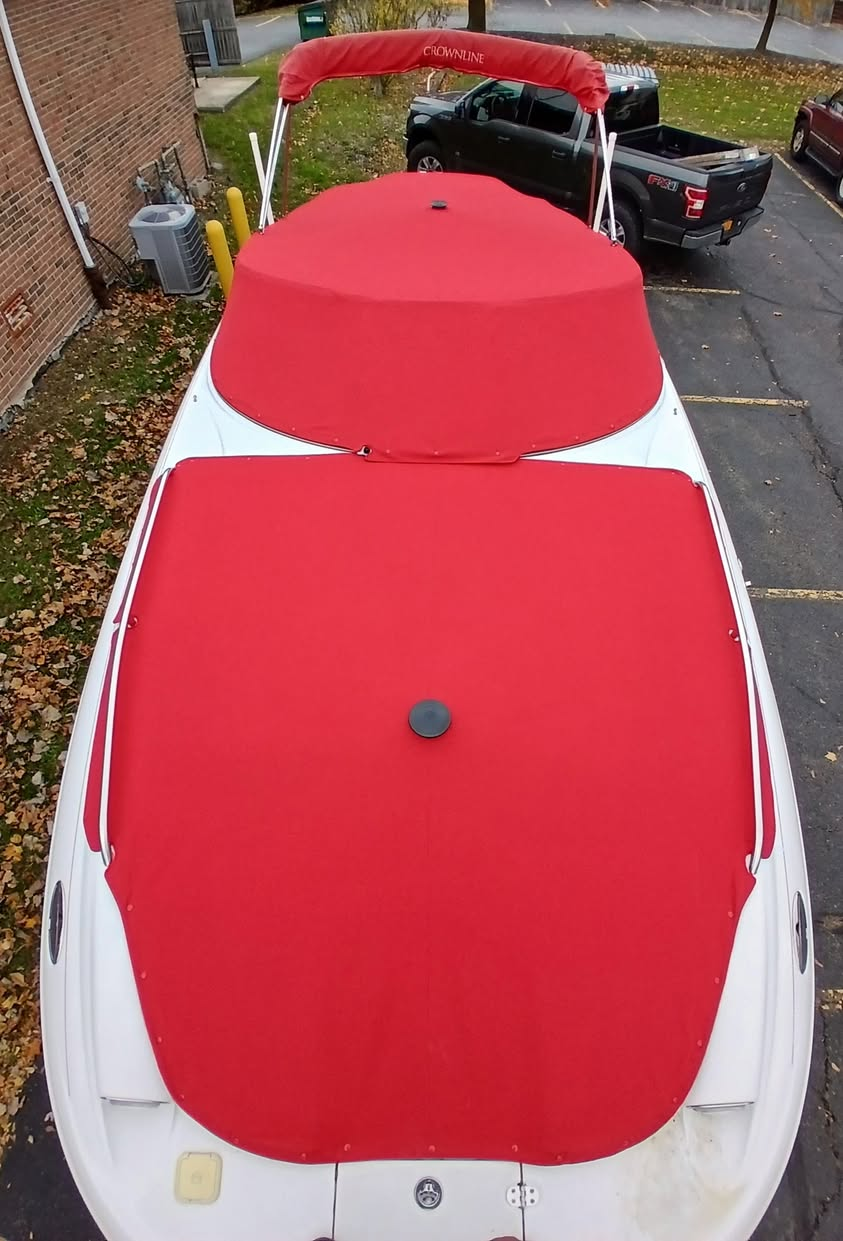 Bright red custom canvas cover set installed on a Crownline boat